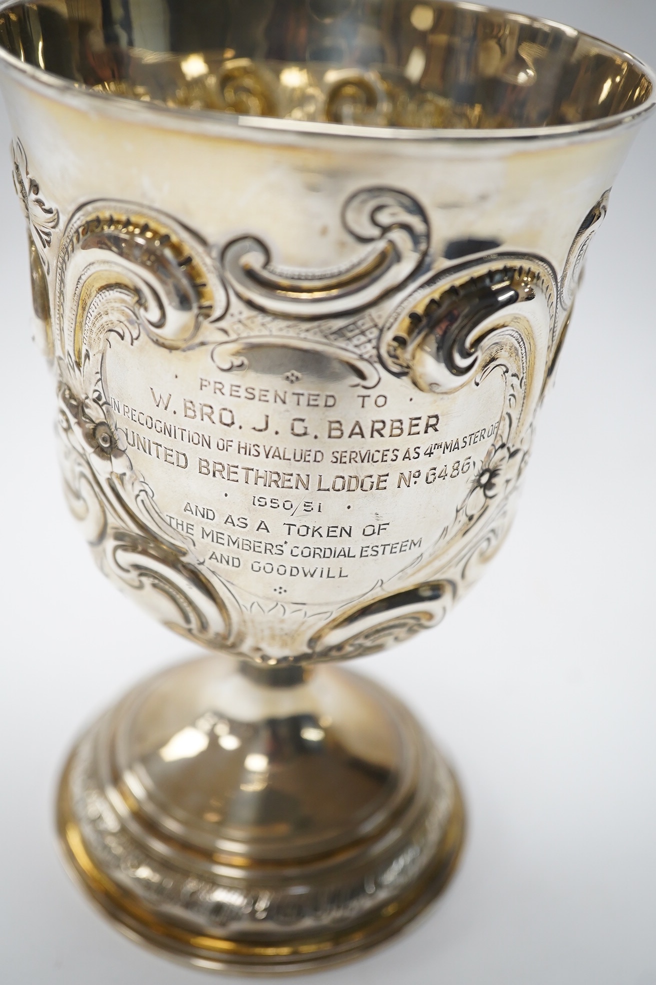 A George II silver goblet, with later embossed decoration and inscription, maker RB London, 1728, 16.6cm, 8.9oz. Condition - fair